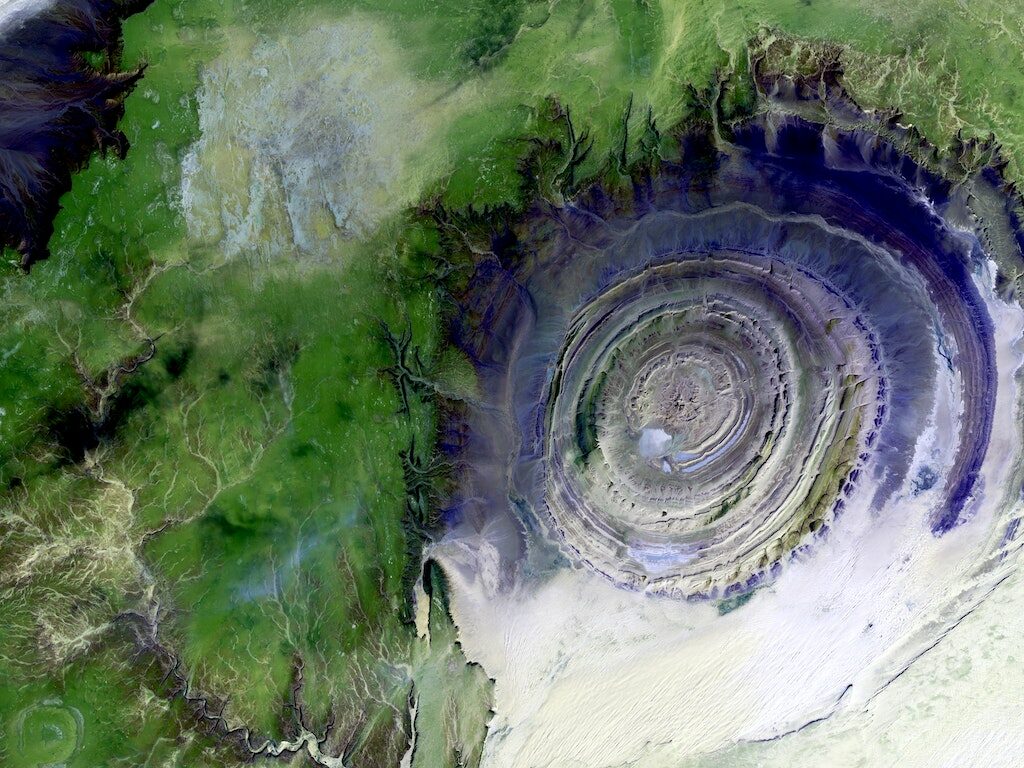 Swirling green and purple view of Maur Adrar Desert from space