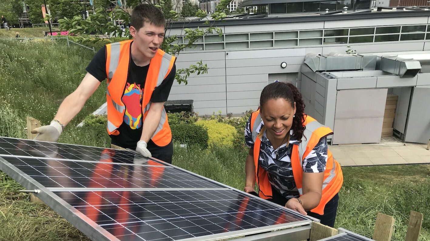 Wholegrain Digital staff installing solar panels to generate their own renewable energy