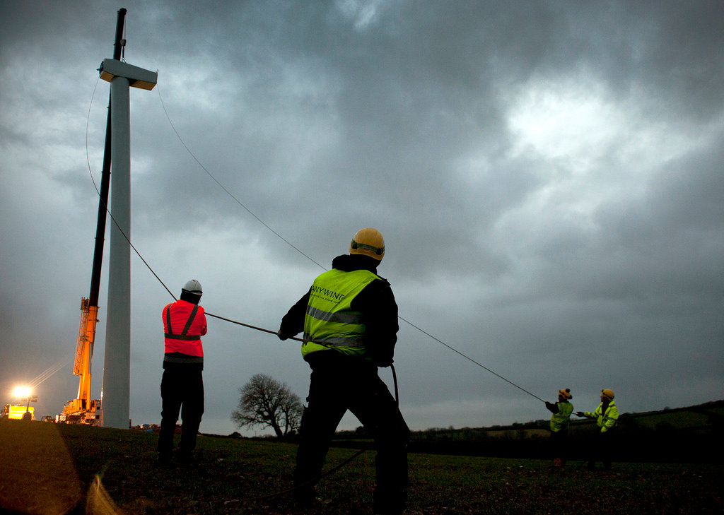 Workers installing a new crowd funded turbine
